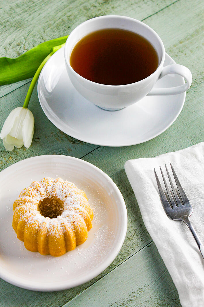 A miniature bundt cake on a small plate.